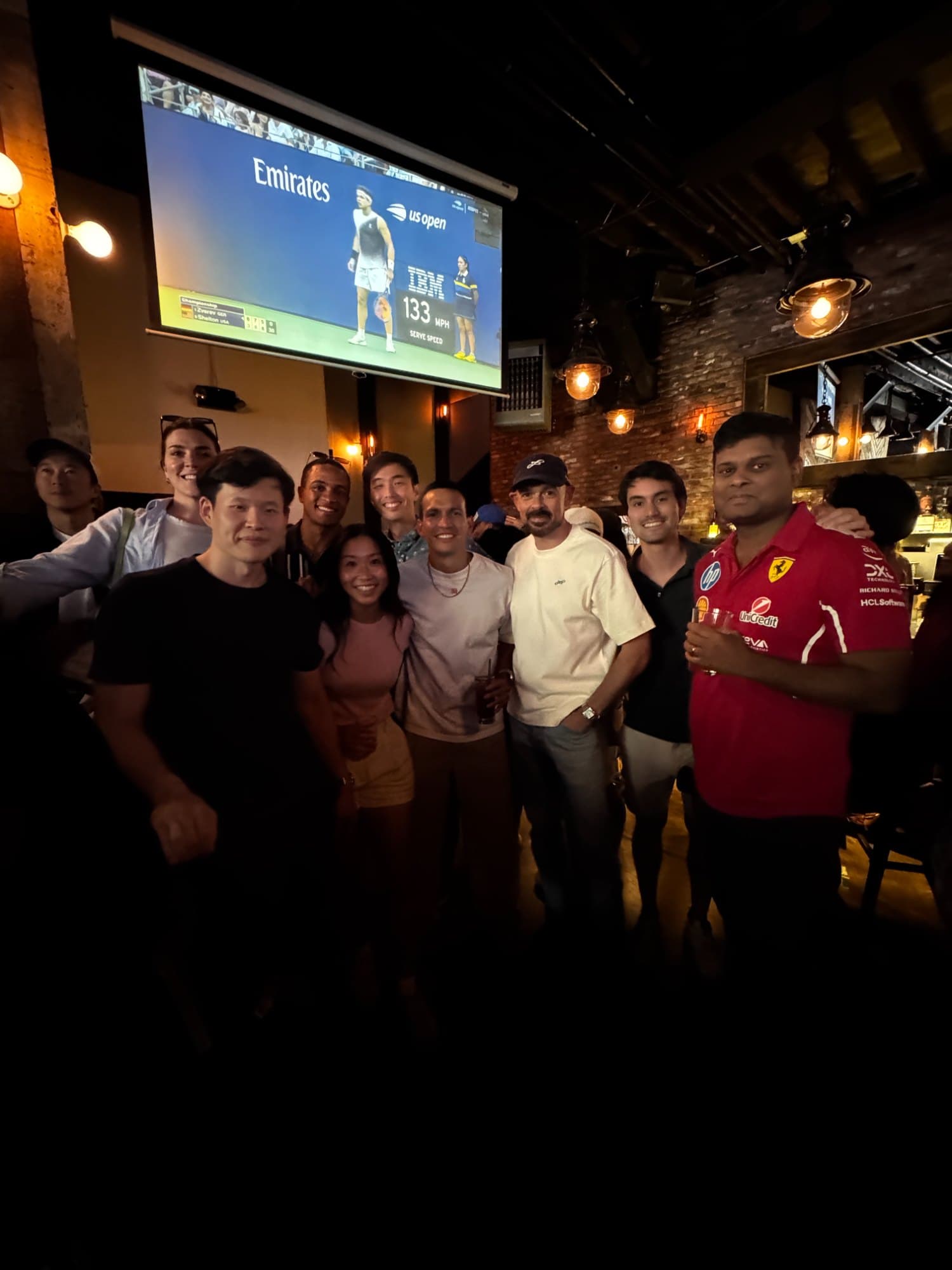 Deuce players at happy hour, the US Open on the screen behind them